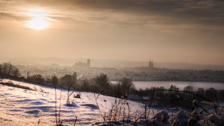 Winter landscape with snow covered fields and the town of Soissons in the background at sunriseの写真素材