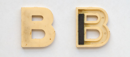 bright plastic cyrillic letters with magnet on white paperの写真素材