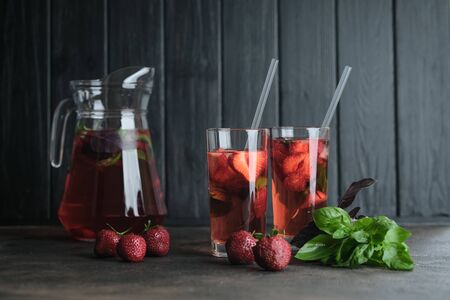 Homemade strawberry lemonade with basil on a dark background.の写真素材