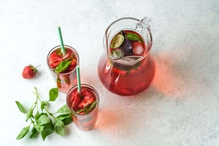 Homemade strawberry lemonade with basil on a light background.の写真素材