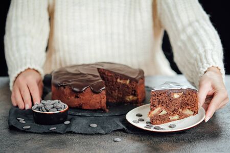Traditional italian chocolate cake with apples and cinnamon on a dark backgroundの写真素材