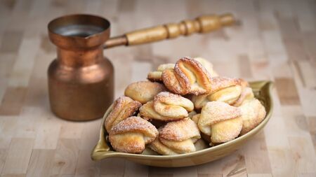 Cookies with cottage cheese and sugar in a rustic bowl on a dark background top view free copy...