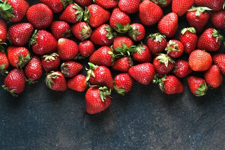 The fresh strawberries frame on a dark backgroundの写真素材