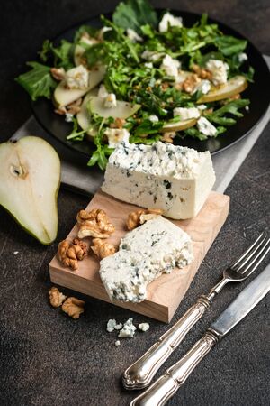Pears, blue cheese and nuts on a dark background. Ingredients for the salad.の写真素材