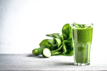 Organic berry and vegetable smoothie with oatmeal on a light background copy space. Healthy food. Lactose free diet.の写真素材