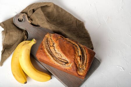 Banana bread with bananas on a light background copy space.の写真素材