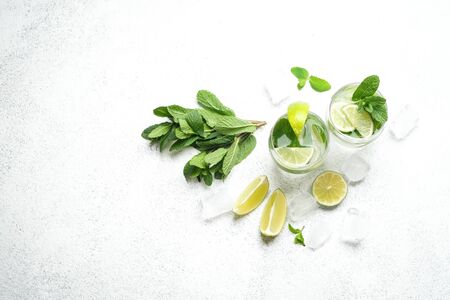 Refreshing mojito cocktail  with mint, rum and lime, cold drink or beverage with ice on white background, top viewの写真素材