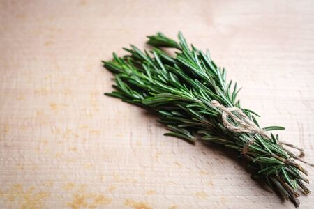 Bunch of fresh rosemary on a black background.Top view with copy space.の写真素材