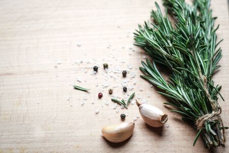 Bunch of fresh rosemary and garlic on a black background.Top view with copy space.の写真素材