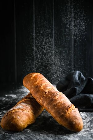 Traditional french baguettes on a dark background top view copy space.の写真素材