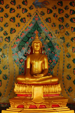Gold buddha statue and wall painting flower pattern at Wat Arun in Bangkok, Thailandの写真素材