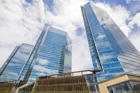 highrise glass building with sky and clouds reflection