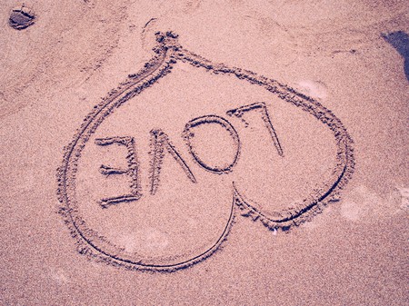 LOVE, written on sandy beachの写真素材