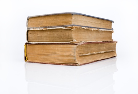 Old books piled together over white background