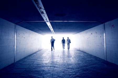 Silhouettes in a subway tunnelの写真素材