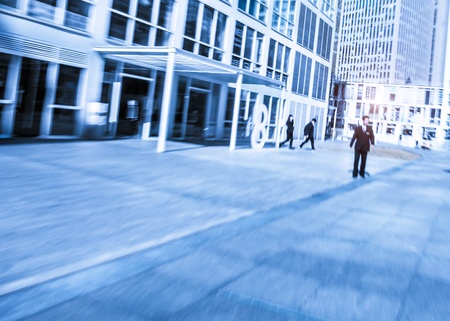 People walking in the business district, with skyscrapers の写真素材