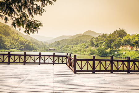 platform beside lake in park,chinaの写真素材