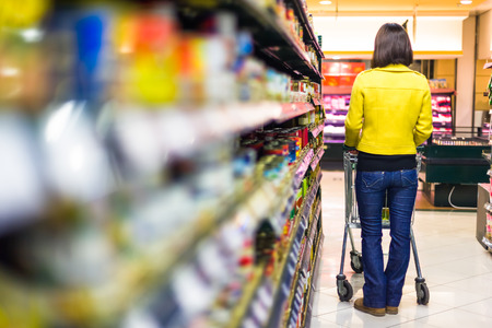 Young woman shopping in the supermarketの写真素材