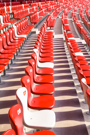 Red chairs bleachers in large stadiumのeditorial素材
