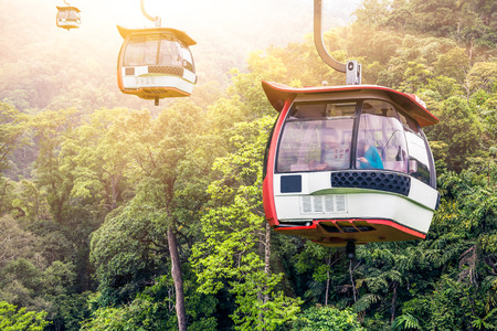 Aerial tramway moving up in tropical jungle mountains Aerial tramway moving up in tropical jungle mountains