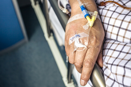 The patient's hand on the bedの写真素材
