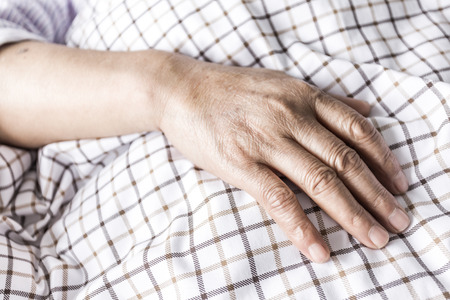 The patient's hand on the bedの写真素材