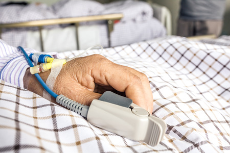 The patient's hand on the bed