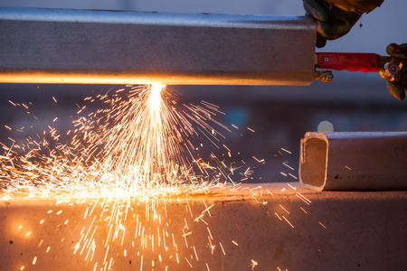 worker cutting steel pipe using metal torch and install roadside fenceの写真素材