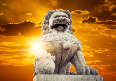 Chinese Imperial Lion Statue at sunsetの写真素材