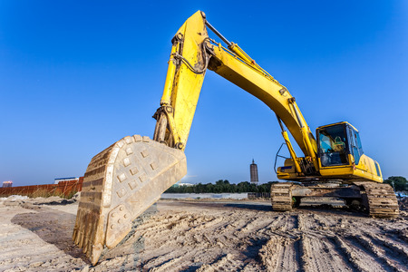 Big excavator on new construction site
