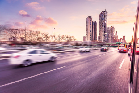 Car driving on freeway at sunset, motion blur