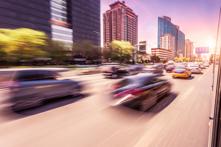 Car driving on road at sunset, motion blurの写真素材