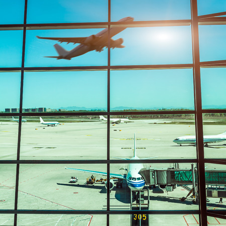 airport windows and airplane at sunsetのeditorial素材