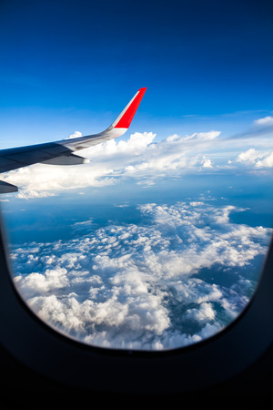 Clouds and sky as seen through window of an aircraftの写真素材