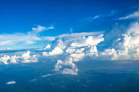 Clouds and sky as seen through window of an aircraftの写真素材