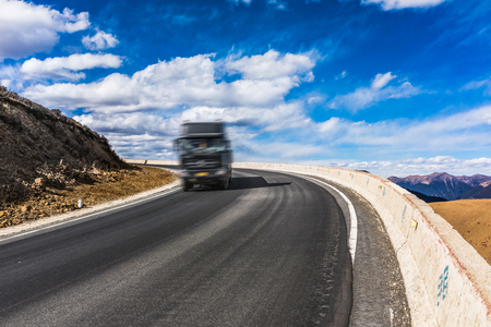 road through grassland in plateau of Tibet Chinaの写真素材
