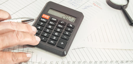 Market analysis and financial reporting using a calculator, business conceptの写真素材