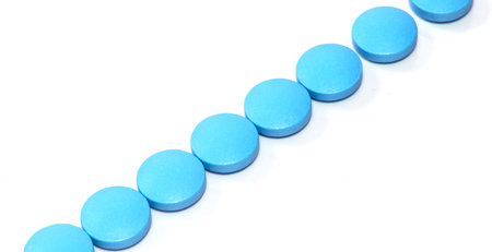 Pharmacology concept, blue pills on white isolated background, line shape, horizontal bannerの写真素材