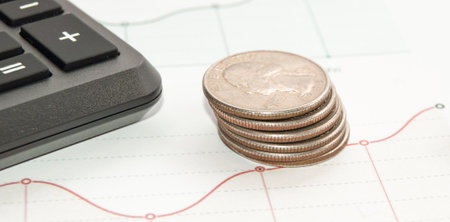 Concept of Finance and planning, Business diagram on financial report with coins and calculatorの写真素材