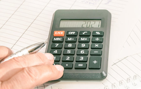 Market analysis and financial reporting using a calculator, business conceptの写真素材