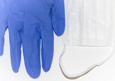 White surgical mask and blue latex gloves on a purple surface. Concept of Covid-19, coronavirusの写真素材