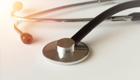 Close-up of a medical stethoscope on a white background with a glow effect, the concept of medicineの写真素材