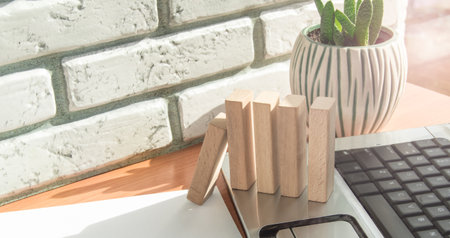 Business planning concept, insurance and risks, wooden blocks and a computer on the Desk in the officeの写真素材