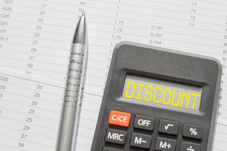 The word tax discount words written on the calculator, pen on the background of accounting reportsの写真素材