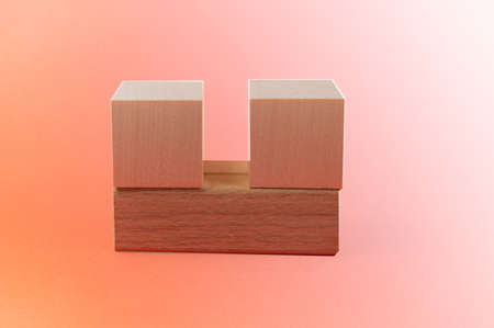 Empty wooden cube-shaped calendar on a pink and beige background, mockup, copy of the spaceの写真素材