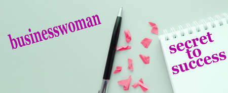 The secret of success text on a notepad, pen on a gray background, workplace businesswomanの写真素材