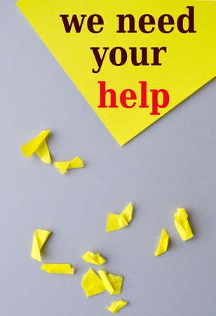 Text I need your help written on a yellow background, gray desktop with torn paper, business donation concept, verticalの写真素材