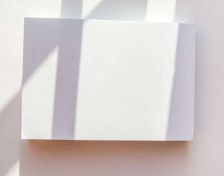 Blank notepad page layout with white sheets and geometric pattern shadow overlay effectの写真素材