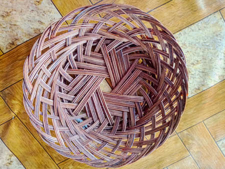 Rattan is used to store food.  shaped like a plate on the table.の写真素材