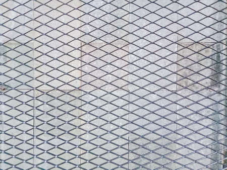 black metal trellis, with brick wall background.の写真素材